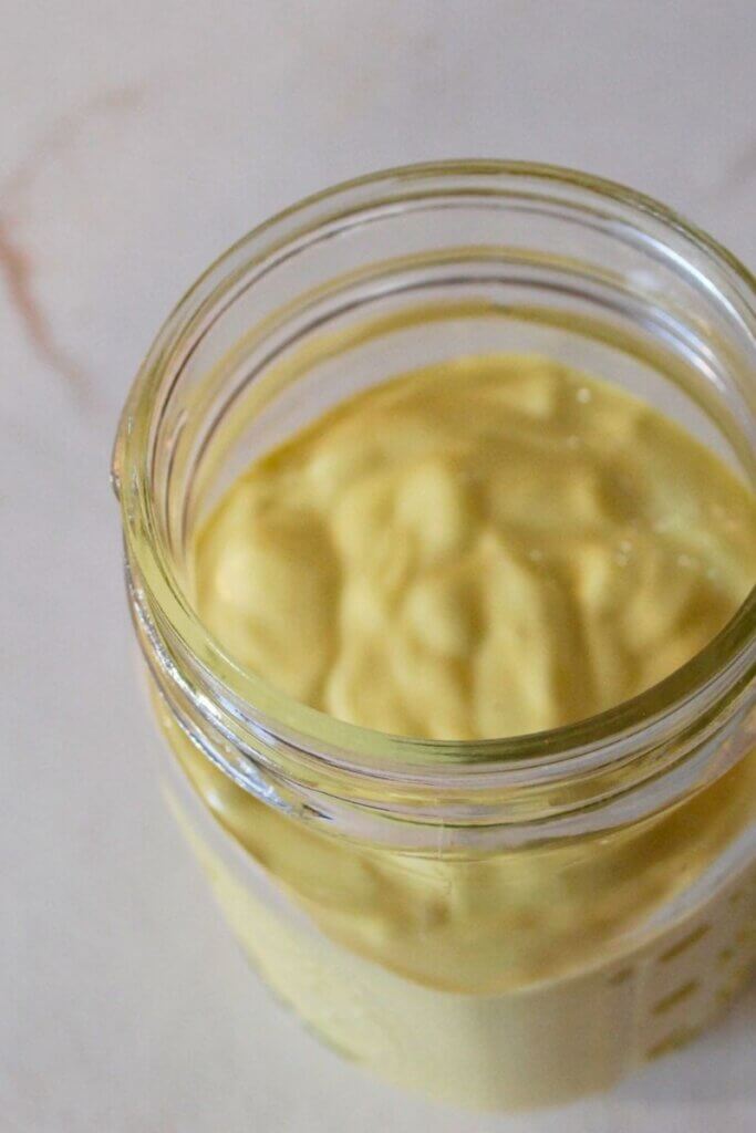 Top view of freshly blended homemade mayonnaise in a glass jar
