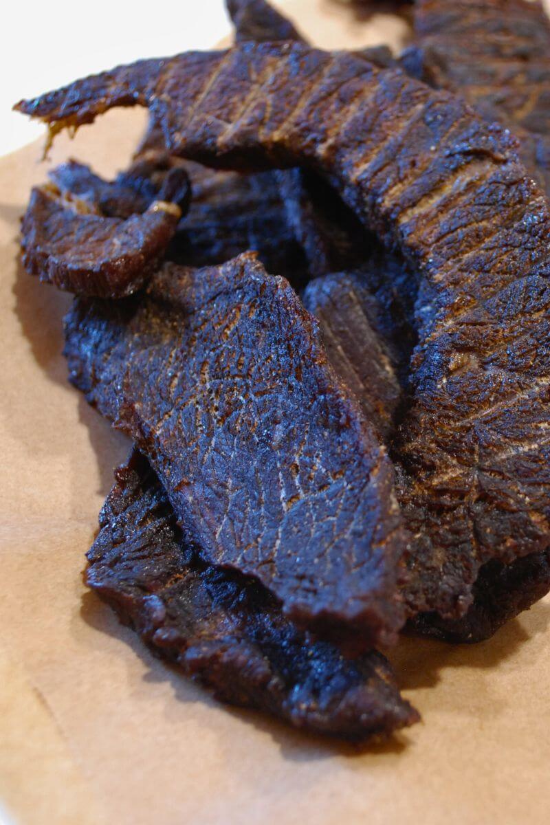 Finished homemade beef jerky made with rump roast, dried until tender and ready to eat.