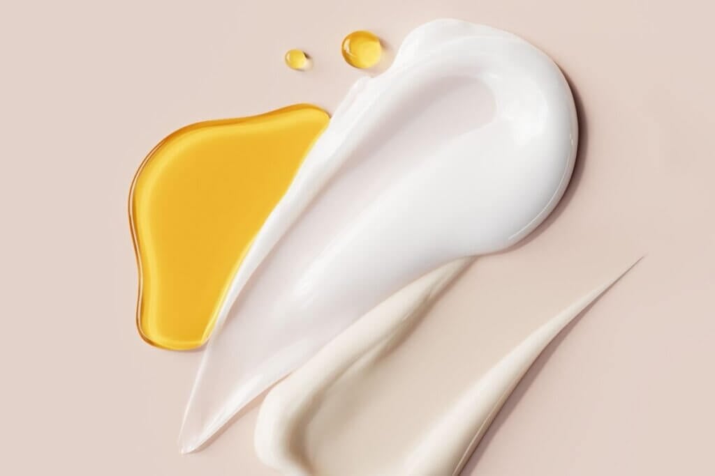 Beef tallow lotion recipe with calendula showing creamy whipped texture and infused oil