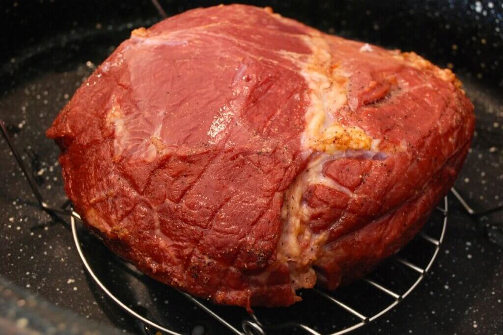 cured roast beef in a roasting pan after it's been cooked.