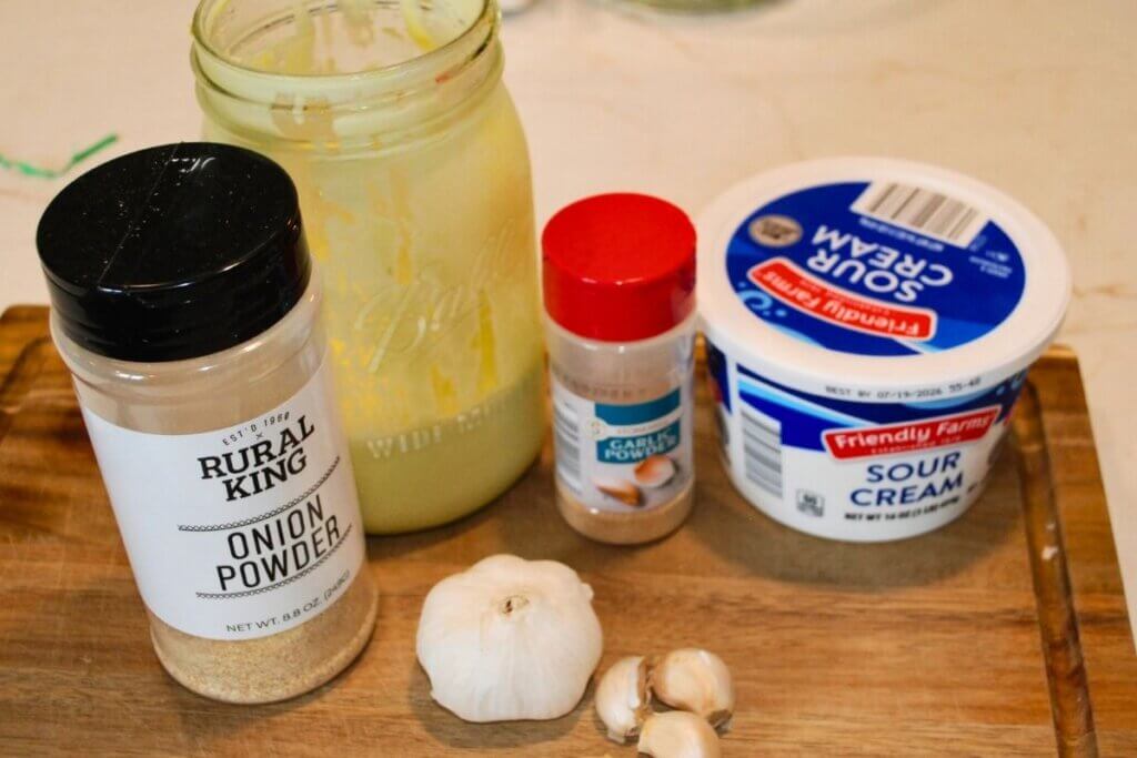 Ingredients for creamy garlic dip and dressing arranged before mixing.