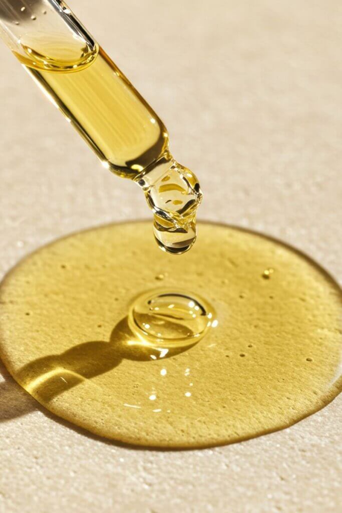 Golden jojoba oil used to moisturize dry hair and support a healthy scalp.